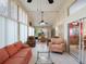 Relaxing sunroom with tile flooring, comfortable seating, and large windows offering natural light at 25243 River Crest Dr, Leesburg, FL 34748