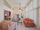 Inviting sunroom with tile floors, neutral-toned furniture, and plenty of natural light from large windows at 25243 River Crest Dr, Leesburg, FL 34748