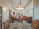 Spacious sunroom with dining area, comfortable seating, and abundant natural light from surrounding windows at 25243 River Crest Dr, Leesburg, FL 34748