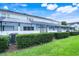 Private backyard with screened in patio, lush lawn, and mature hedges for privacy at 2530 Maneshaw Ln, Kissimmee, FL 34747