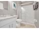Modern bathroom featuring a glass enclosed shower, a white toilet, and a granite countertop at 2530 Maneshaw Ln, Kissimmee, FL 34747