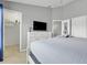 Bedroom showcasing a queen-size bed, a television, and a walk-in closet, perfect for comfortable living at 2530 Maneshaw Ln, Kissimmee, FL 34747