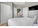 Cozy bedroom featuring a queen-size bed, a television, and ample natural light, creating a relaxing atmosphere at 2530 Maneshaw Ln, Kissimmee, FL 34747