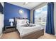 Comfortable bedroom with a large window, stylish decor, and a cozy ambiance at 2530 Maneshaw Ln, Kissimmee, FL 34747