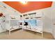 bedroom showcasing bunk beds, whimsical wall art, and a playful atmosphere for creative dreams at 2530 Maneshaw Ln, Kissimmee, FL 34747