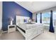 Stylish bedroom with accent wall, bedside lamps, and ample natural light through the window at 2530 Maneshaw Ln, Kissimmee, FL 34747