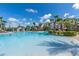 This community pool offers a resort-like experience with its ample space, lounge chairs, and playful water features at 2530 Maneshaw Ln, Kissimmee, FL 34747