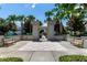 Stone castle entrance with palm trees, benches, and checkerboard paving at 2530 Maneshaw Ln, Kissimmee, FL 34747