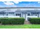 Rear exterior view featuring a screened lanai, white privacy walls, and tidy landscaping on a sunny day at 2530 Maneshaw Ln, Kissimmee, FL 34747