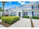 Desirable light blue townhome with charming curb appeal and well-maintained landscaping at 2530 Maneshaw Ln, Kissimmee, FL 34747