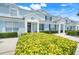 Inviting townhouse complex with light blue exterior, well-kept landscaping and private entrances at 2530 Maneshaw Ln, Kissimmee, FL 34747