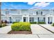 Charming townhome community with light blue exteriors, blue shutters, and beautiful landscaping at 2530 Maneshaw Ln, Kissimmee, FL 34747