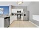 Modern kitchen featuring stainless steel appliances, granite countertops, and sleek white cabinetry at 2530 Maneshaw Ln, Kissimmee, FL 34747