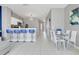 Open concept living room with bar seating and modern decor leading to dining room and entry area at 2530 Maneshaw Ln, Kissimmee, FL 34747
