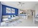 Open concept living room with bar seating and modern decor leading into kitchen and dining area at 2530 Maneshaw Ln, Kissimmee, FL 34747
