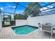 Relaxing screened-in pool area with tile flooring, outdoor seating and views at 2530 Maneshaw Ln, Kissimmee, FL 34747