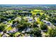 Aerial view of a property near green fields, ponds, and mature trees at 2711 Bayview Dr, Eustis, FL 32726