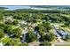 An aerial view showcases the property's neighborhood near lush trees and a serene lake at 2711 Bayview Dr, Eustis, FL 32726