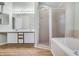 Bright bathroom featuring double sinks, walk-in shower, and soaking tub at 2711 Bayview Dr, Eustis, FL 32726