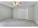 Bedroom with carpet, ceiling fan, and closet doors, offering a spacious and clean living space at 2711 Bayview Dr, Eustis, FL 32726