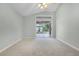 Bright bedroom featuring neutral paint, carpet, and sliding glass doors at 2711 Bayview Dr, Eustis, FL 32726