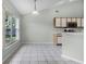 Bright kitchen and dining area with tile floor and a large window offering a view of the backyard at 2711 Bayview Dr, Eustis, FL 32726