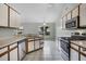 A clean kitchen featuring white appliances and cabinetry, ample counter space, and tile flooring at 2711 Bayview Dr, Eustis, FL 32726
