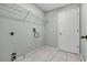 Bright laundry room featuring tile floors, built in storage rack, and neutral paint at 2711 Bayview Dr, Eustis, FL 32726