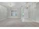 Bright, airy living room with neutral carpet, large windows, and ample natural light, creating an open and inviting space at 2711 Bayview Dr, Eustis, FL 32726