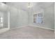 Spacious carpeted living room with neutral paint, a large window, and high ceilings providing a bright and airy atmosphere at 2711 Bayview Dr, Eustis, FL 32726