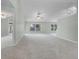 Expansive living area with neutral carpeting, recessed lighting, ceiling fans, and access to outdoor living spaces at 2711 Bayview Dr, Eustis, FL 32726