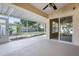 Covered patio with screened enclosure and view of backyard at 2711 Bayview Dr, Eustis, FL 32726