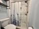 Bathroom with tiled shower, floral curtain, and decorative shelving offering a stylish and functional space at 2850 Aragon Ter, Lake Mary, FL 32746