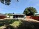 Fenced backyard with a screened-in patio, lawn, and mature trees at 2850 Aragon Ter, Lake Mary, FL 32746
