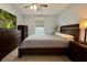Cozy bedroom with carpeted floors, a ceiling fan, and dark wood furniture set at 2850 Aragon Ter, Lake Mary, FL 32746