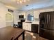 Kitchen features black appliances, white cabinetry, archway, and an adjacent breakfast nook at 2850 Aragon Ter, Lake Mary, FL 32746