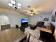 Spacious living room featuring modern decor, a ceiling fan, and a large television at 2850 Aragon Ter, Lake Mary, FL 32746