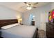 Comfortable bedroom featuring a ceiling fan, archway to bath, and a large window at 2850 Aragon Ter, Lake Mary, FL 32746