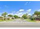 Street view showing the Chase Groves community entrance sign, palms, and the neighborhood street at 2850 Aragon Ter, Lake Mary, FL 32746