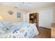 Comfortable bedroom with ceiling fan, closet, bookshelf, and bed with a blue and white floral cover at 3008 Bridgefield Ct, The Villages, FL 32162