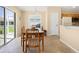 Bright dining room with tile floors, large window, sliding doors to the lanai, and open kitchen at 3008 Bridgefield Ct, The Villages, FL 32162