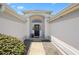 Inviting entryway featuring a modern door and decorative landscaping, creating an appealing facade at 3008 Bridgefield Ct, The Villages, FL 32162