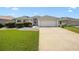 Charming single-story home featuring a well-manicured lawn, paved driveway, and a two-car garage at 3008 Bridgefield Ct, The Villages, FL 32162