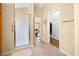 Hallway featuring tile shower, walk in closet and bedroom with hardwood floors at 3008 Bridgefield Ct, The Villages, FL 32162