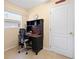 Small home office nook featuring desk, chair, window, and tile floors at 3008 Bridgefield Ct, The Villages, FL 32162