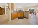 Open kitchen design with wood cabinets, stainless steel appliances, and granite countertops at 3008 Bridgefield Ct, The Villages, FL 32162