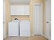 Clean laundry room with white washer, dryer, cabinets, and tile floors at 3008 Bridgefield Ct, The Villages, FL 32162
