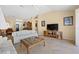 Bright living room with tile floors, neutral walls, comfortable seating, and media center at 3008 Bridgefield Ct, The Villages, FL 32162