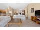 Spacious living room featuring tile flooring and comfortable seating, with a view towards the dining area at 3008 Bridgefield Ct, The Villages, FL 32162