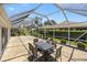Enclosed patio with dining table and chairs offering a spacious area for outdoor gatherings at 3008 Bridgefield Ct, The Villages, FL 32162